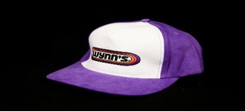 A purple and white Wynns Hat with the word yumms on it.