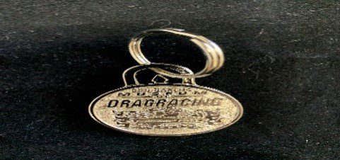 Golden Rat Keychain on a black surface