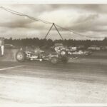 An old photo of a drag race car on a track.