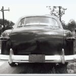 A black and white photograph of a vintage car.