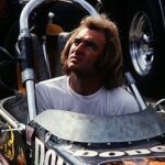 A man seated in a drag racing car.