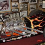 A drag racing car is on display in a museum.