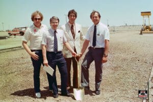 Four men at a groundbreaking ceremony site.