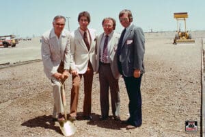 Four men at construction site groundbreaking ceremony.