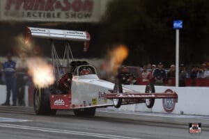 Dragster car accelerating with flames visible.