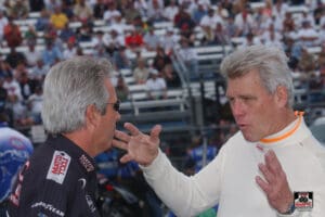 Two men having an animated conversation outdoors.