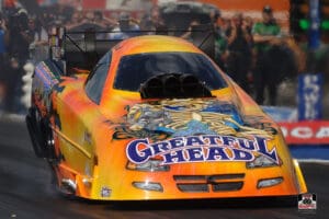 Orange drag racing car on the track.