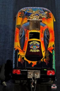 Colorful drag racing car with vibrant artwork.