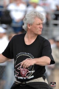 Man wearing a black graphic T-shirt outdoors.