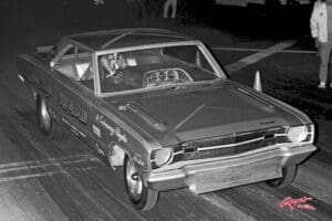 Vintage drag race car on track.