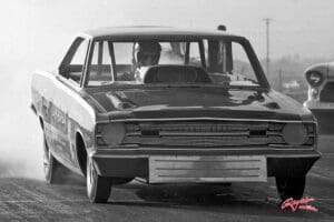 Vintage race car on drag strip.