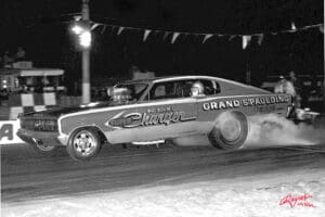 Vintage drag racing car speeding on track.