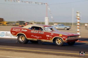 Red drag racing car on the track.