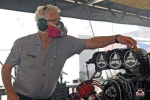 Man working on engine with protective gear.