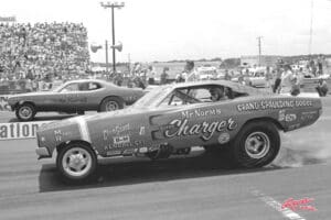 Classic drag race cars at starting line.