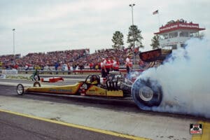 Dragster performing a burnout at race event.