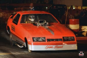 Red drag racing car on the track.