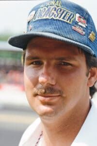 Man wearing a blue cap outdoors.