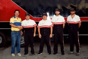 Group of men standing in team uniforms.