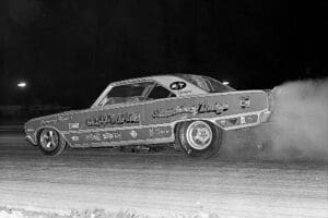 Vintage race car drifting on track.