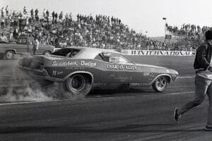 Drag race car speeding on track.