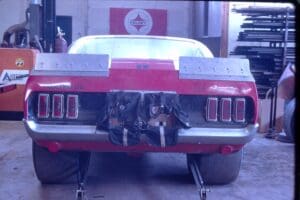 Red race car in a garage workshop.