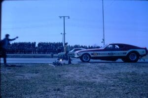 Drag race with crowd and signaling official.
