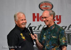 Two men speaking at an event.