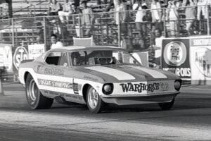 Vintage drag race car on track.