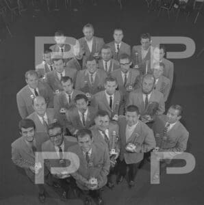 Group of men holding trophies, black and white.