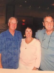 Three people posing at an event.