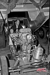 Man sitting in a drag racing car.