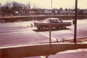 Vintage car at a drag racing event.