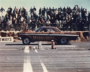 Vintage drag race car at starting line.