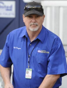 Man in blue shirt and black cap.