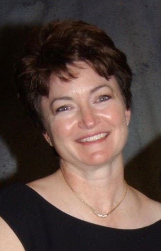 Smiling woman with short brown hair.