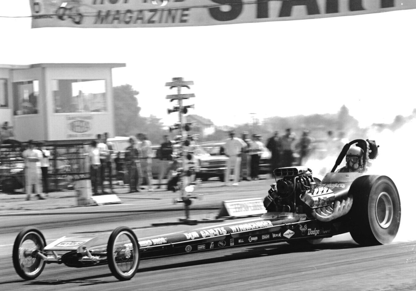 A black and white photo capturing the essence of a drag racer as they speed towards victory.