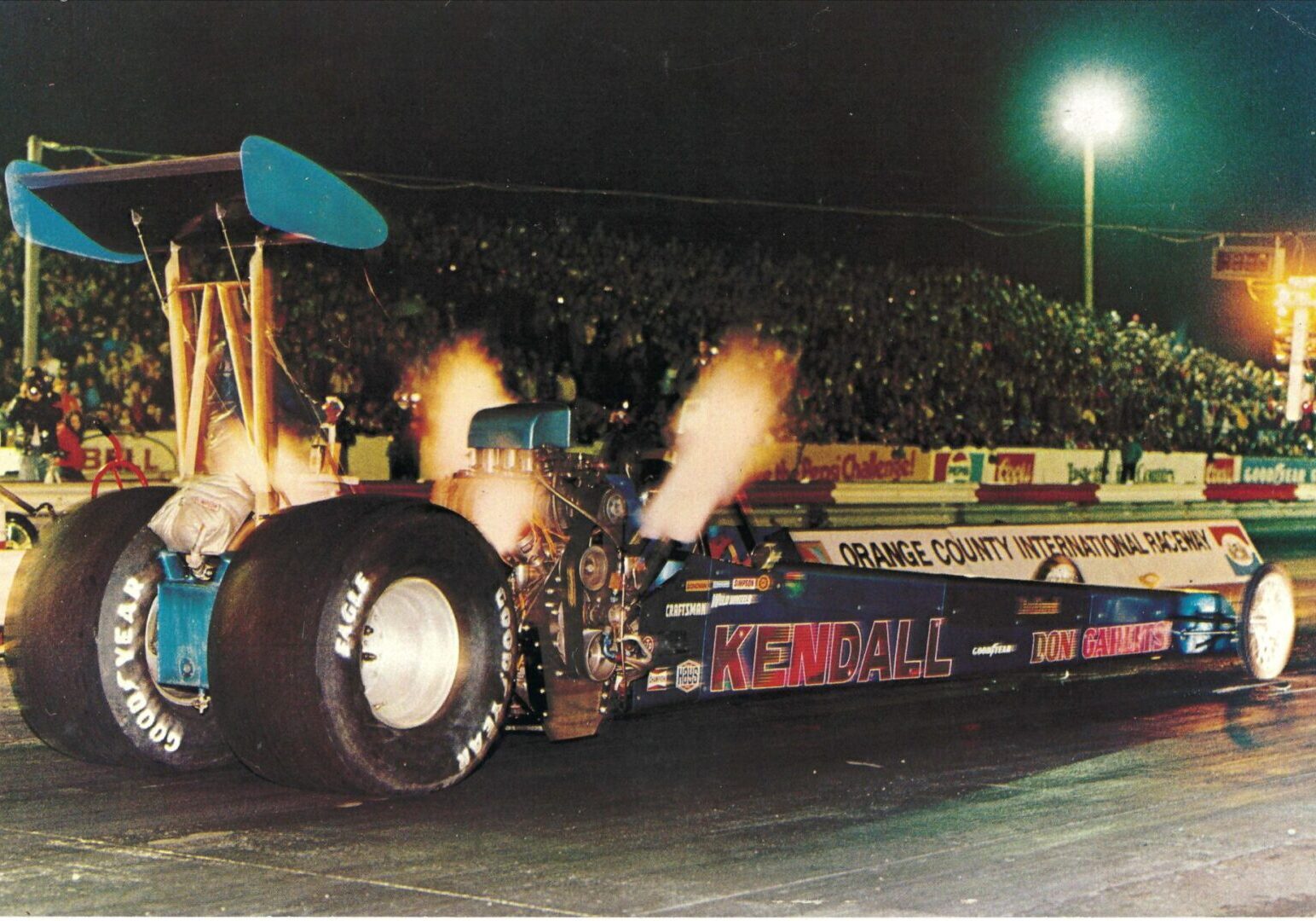 A drag racer with an oversized tire competing in drag racing.